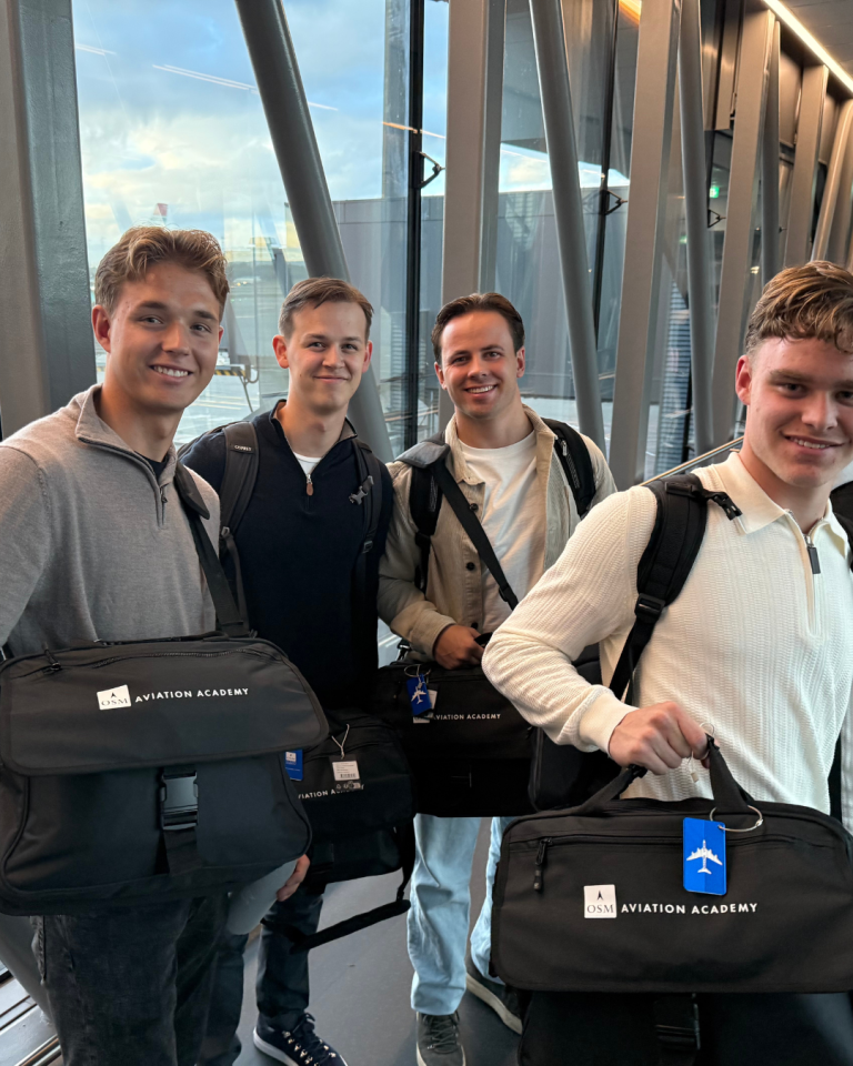 Students holding bags and boarding plane